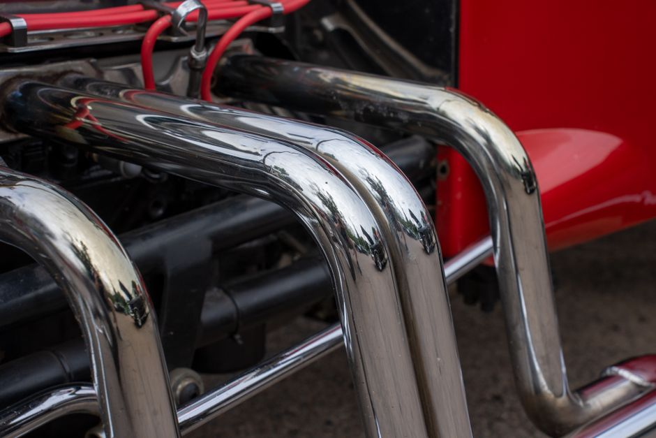 Detailed view of shiny chrome exhaust pipes on a classic hot rod in Nelson, WI.